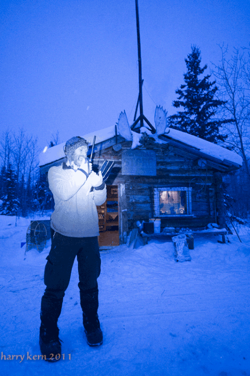 Sebastian Jones uses a satellite phone to post in/out times back to Quest headquarters.