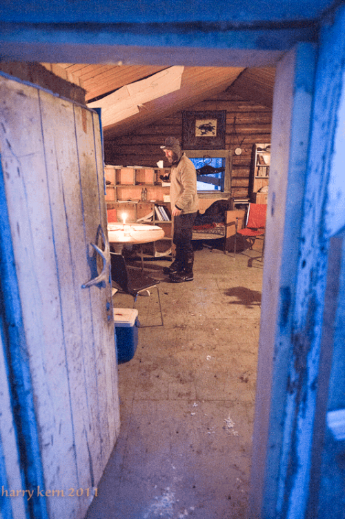 A peek inside the nice warm log cabin at Forty Mile. Sebastian Jones is the host.