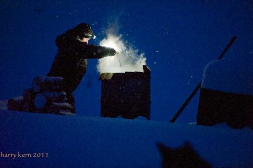 Dallas Seavey draws water from (bottomless) barrel of hot water for his dogs’ food. Easy peesy at Forty Mile!